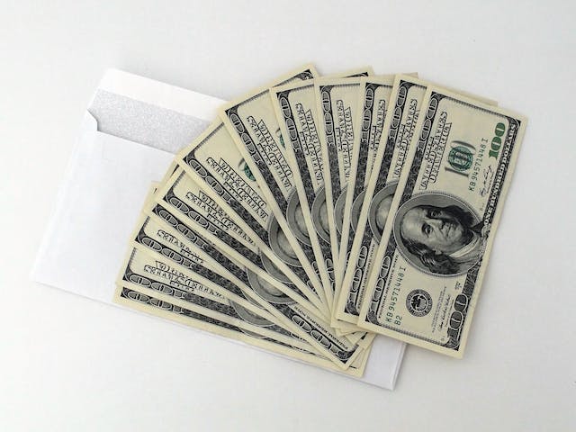 money%20fanned%20out%20on%20top%20of%20an%20envelope
